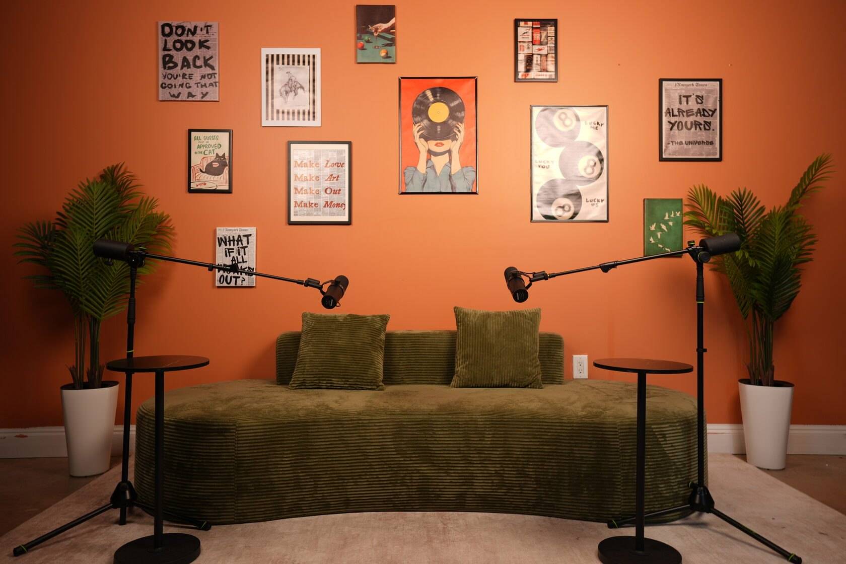 Studio #6 at The Cast Studio: an orange gallery wall and a green corduroy sofa