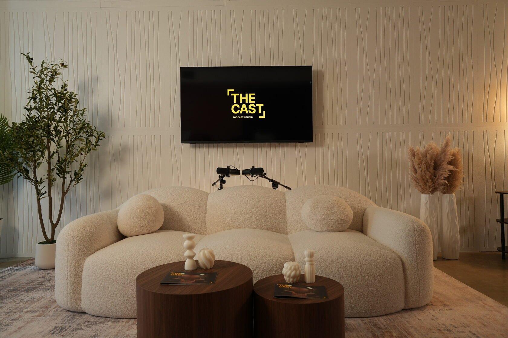 Studio #2 at The Cast Studio: a soft white designer sofa and round wooden tables