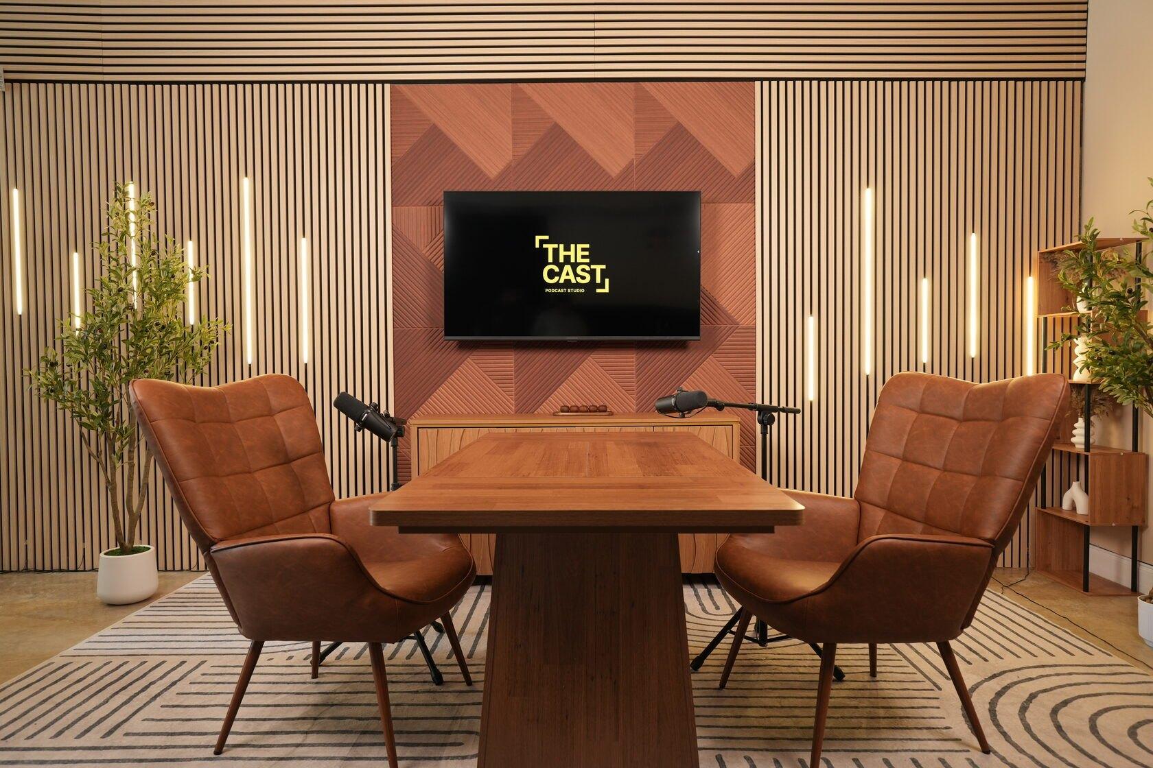 Studio #4 at The Cast Studio: a wooden table with leather chairs for group podcasts