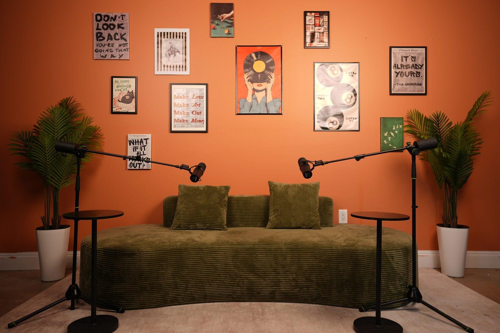 Studio #6 at The Cast Studio: an orange gallery wall and a green corduroy sofa