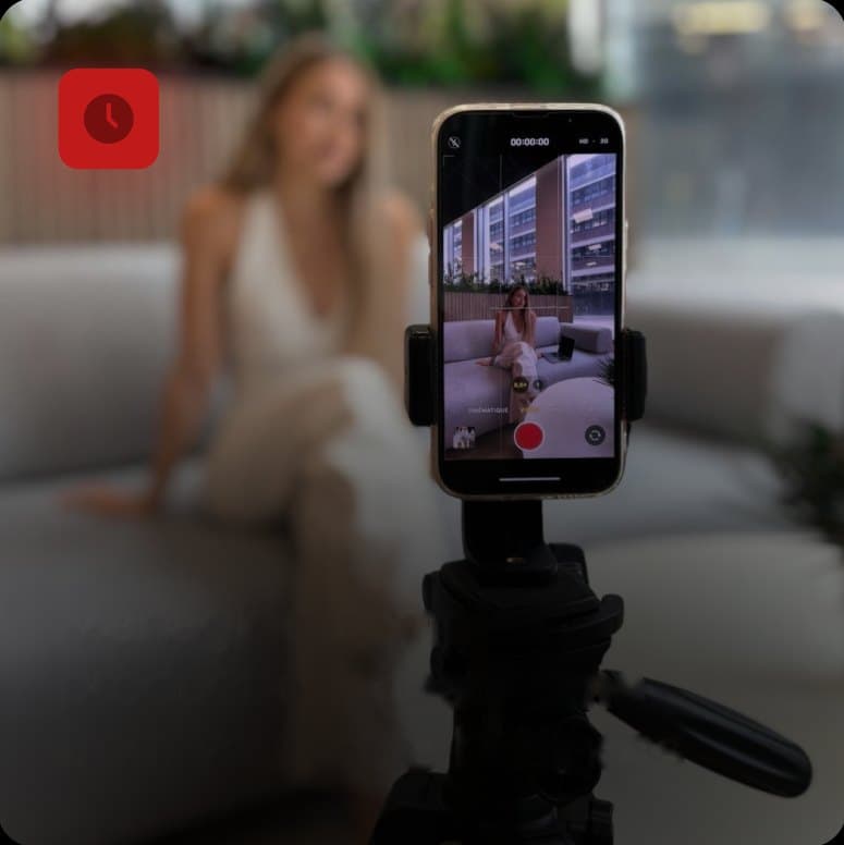 Woman filming herself on a phone mounted on a tripod